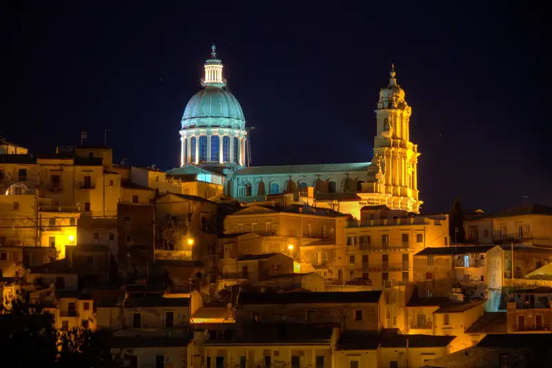 Spectacular night scene of Ragusa's illuminated cathedral with baroque architecture.